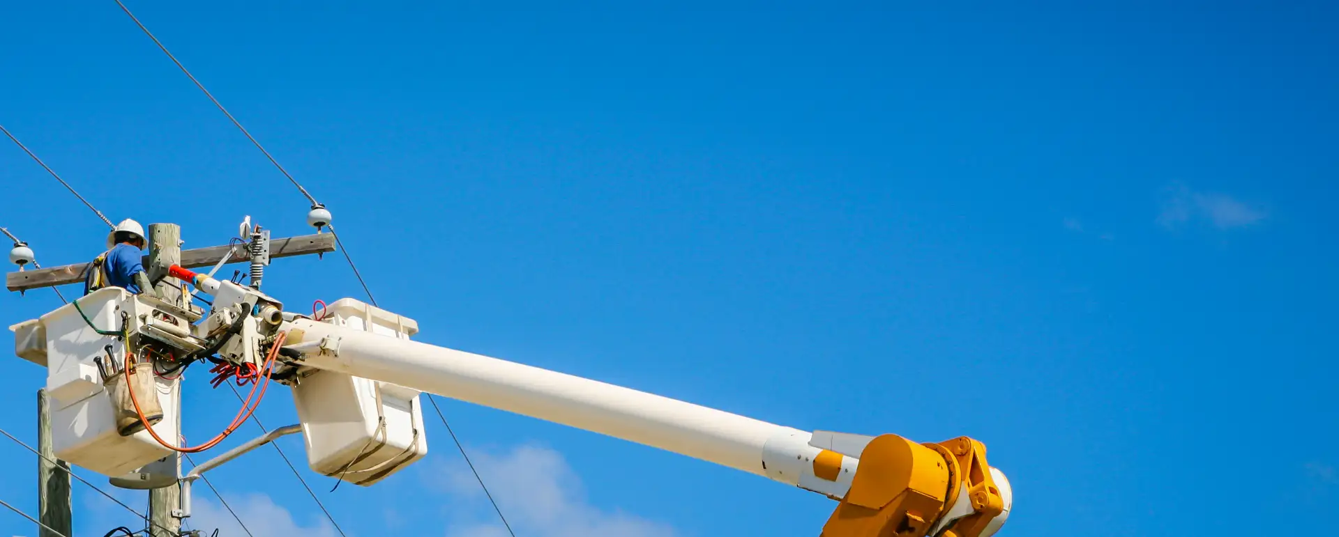 Lineman working from bucket truck on power line