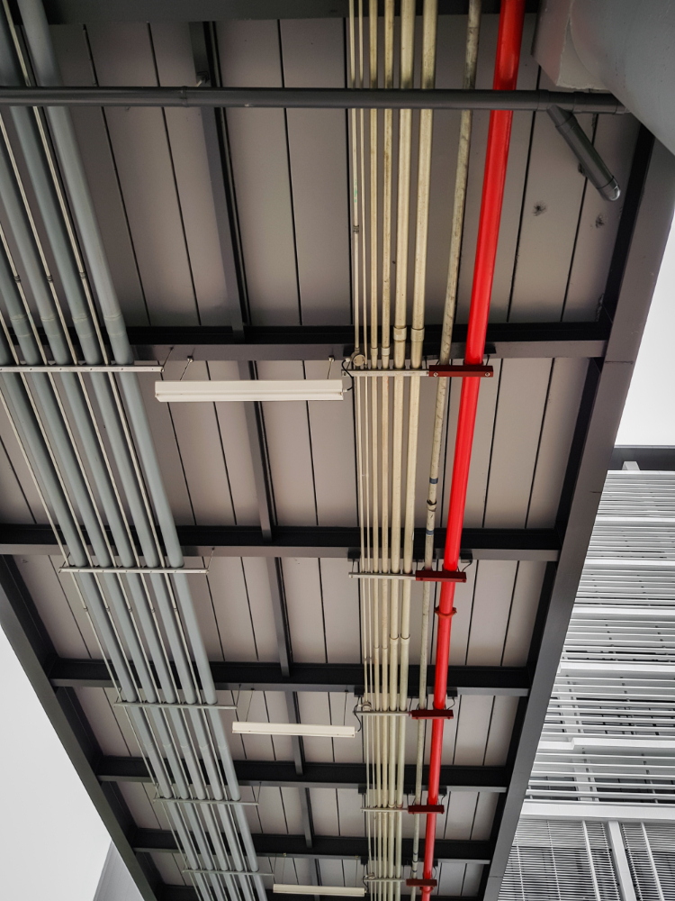 Conduit and cable routing in facility ceiling