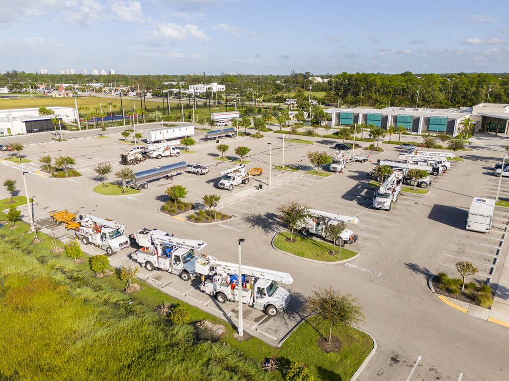 Aerial view of utility truck fleet staged in yard