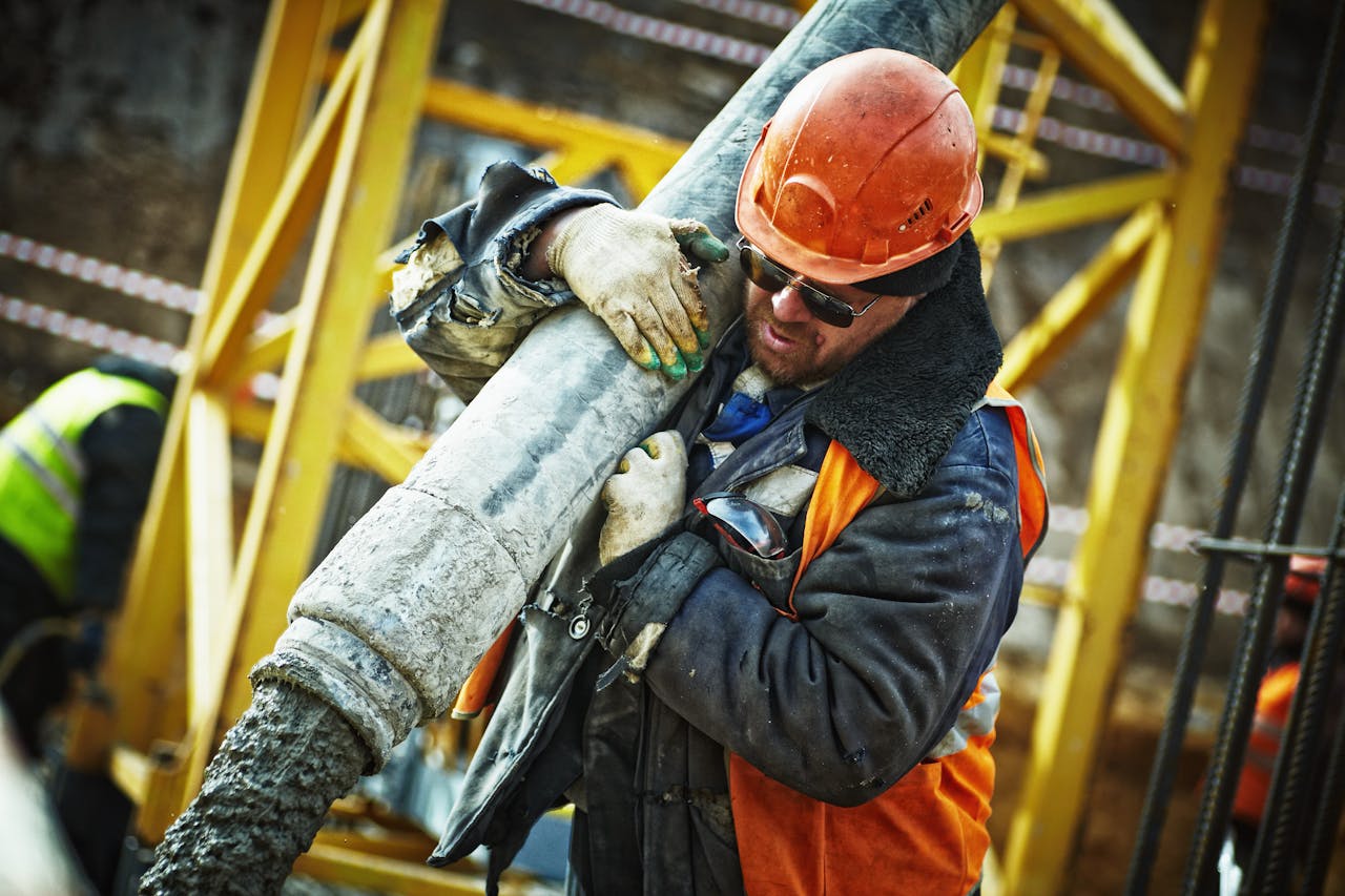 Construction worker handling concrete pour on site