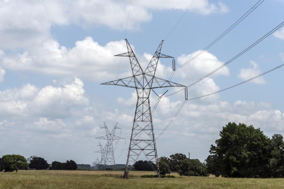 Lattice transmission towers across open field